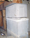 Concrete crawl space support posts in Corbin that are showing signs of failure as they sink into the earth.