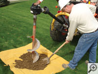 Auguring a hole in the earth for a foundation repair in Versailles