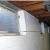 A foundation showing severe inward buckling along the windows in a London home.
