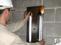 Mounting a foundation wall plate for an earth anchor installation in Campbellsville.