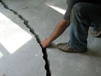 a severely damaged cracked concrete slab floor in Cynthiana