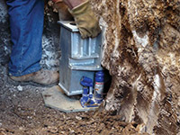 Securing a foundation footing bracket for a foundation repair system in Lawrenceburg.