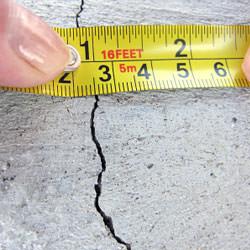 A crack in a poured concrete wall that's showing a normal crack during curing in Pine Knot