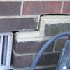 A closeup of a failed tuckpointing job where the brick cracked on a Stearns home.