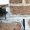 Failed crack repair showing old tuckpointing that cracked on a Georgetown home.