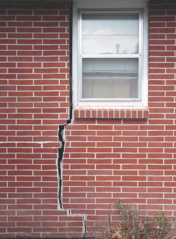 severe foundation wall cracks along a window in Hazard