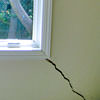 A long, diagonal crack that begins at a window corner of a Wilmore home
