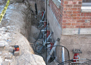 Foundation push piers installed around a house with a foundation settlement issues in Columbia
