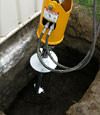 Installing a helical pier during a foundation repair in Nicholasville