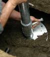 Nicholasville helical pier installation nearing completion, with the blade being advanced into the foundation soils.