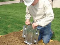 Fastening an earth anchor for a severely bowing wall in Berea.