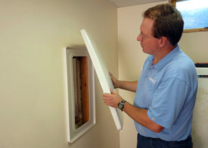 Foundation wall anchor covers installed in a finished basement with a repaired foundation wall in Columbia.
