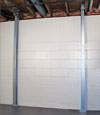 A steel i-beam system installed on a Stearns foundation wall