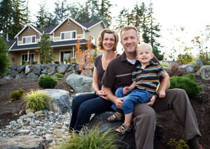 A happy family outside a home with a repaired foundation in East Bernstadt