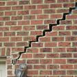 stair step cracking reaching from a window along the foundation wall in Georgetown