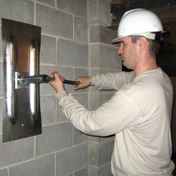 installing a wall anchor to repair an bowing foundation wall in Somerset