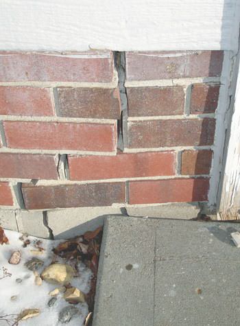 Severe street creep damage to a garage wall outside a Whitley City home
