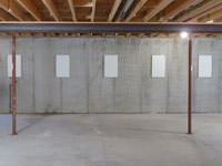 A repaired basement wall with foundation wall anchor covers installed in Berea.