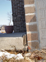 Driveway in contact with the foundation leading to street creep damage