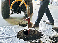 Digging the hole used for wall anchor installation in Monticello.