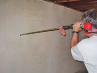 Drilling the hole in the foundation wall for street creep repairs in Lebanon