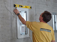Positioning a wall plate cover on a foundation wall in Shelbyville.