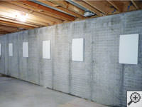 Wall anchor covers installed along a foundation wall that has been straightened in Stearns.