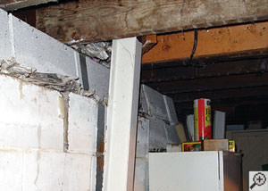 A failing foundation wall and i-beam support in a Lexington home