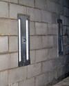 an inside view of foundation wall anchors installed along a basement wall to brace and repair the structure in Harrodsburg