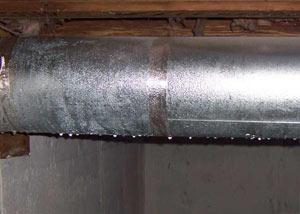 condensation collecting on an HVAC vent in a humid Versailles basement
