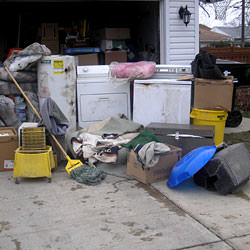 Soaked, wet personal items sitting in a driveway, including a washer and dryer in Shelbyville.