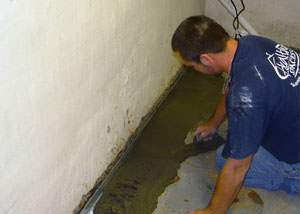 Restoring a concrete slab floor with fresh concrete after jackhammering it and installing a drain system in East Bernstadt.
