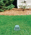 A buried gutter drain downspout extension installed in a Pine Knot home