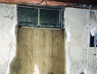 Water pouring out from a basement window in Frankfort